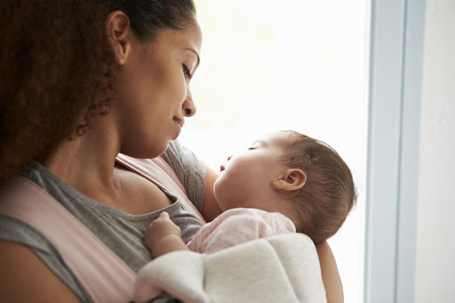 A woman holds her child